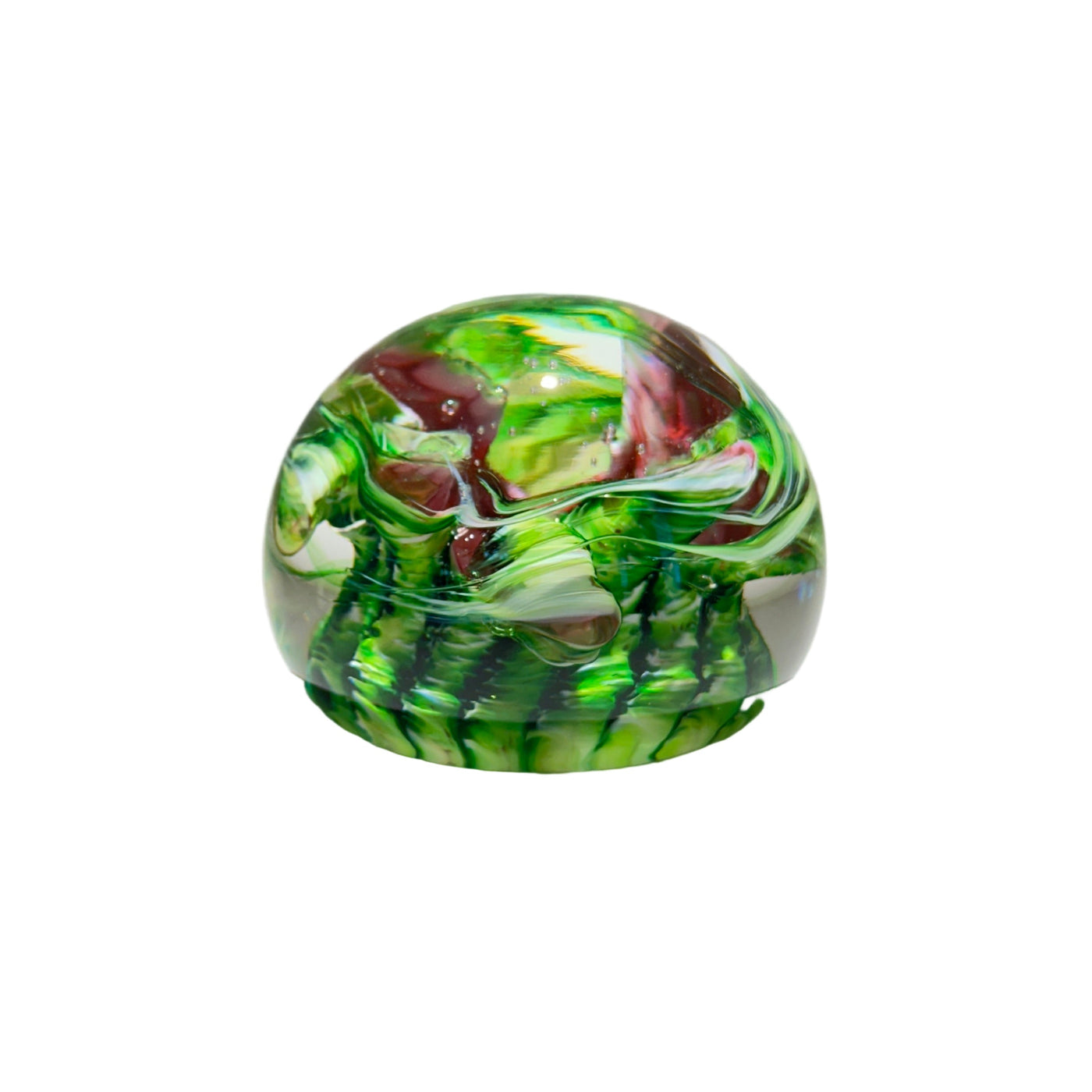 Green and red marbled glass paperweight on a white background