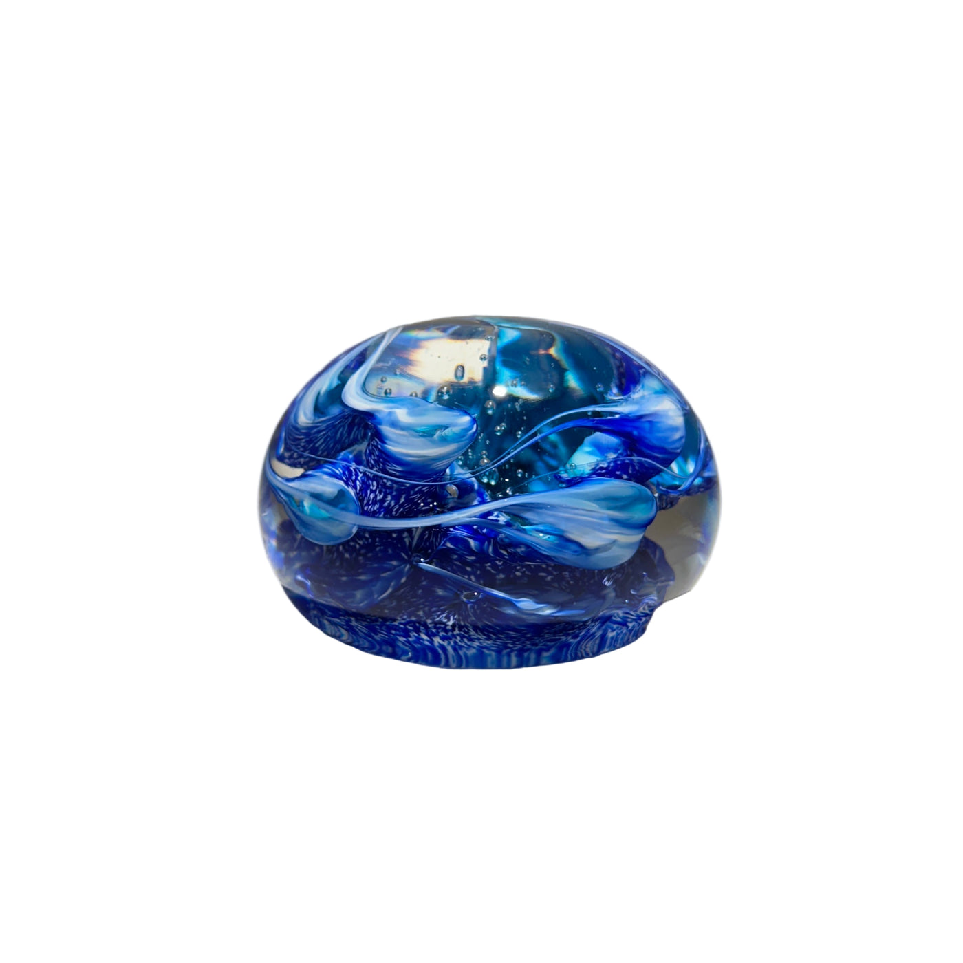 Blue glass paperweight on a light gray surface with a neutral background