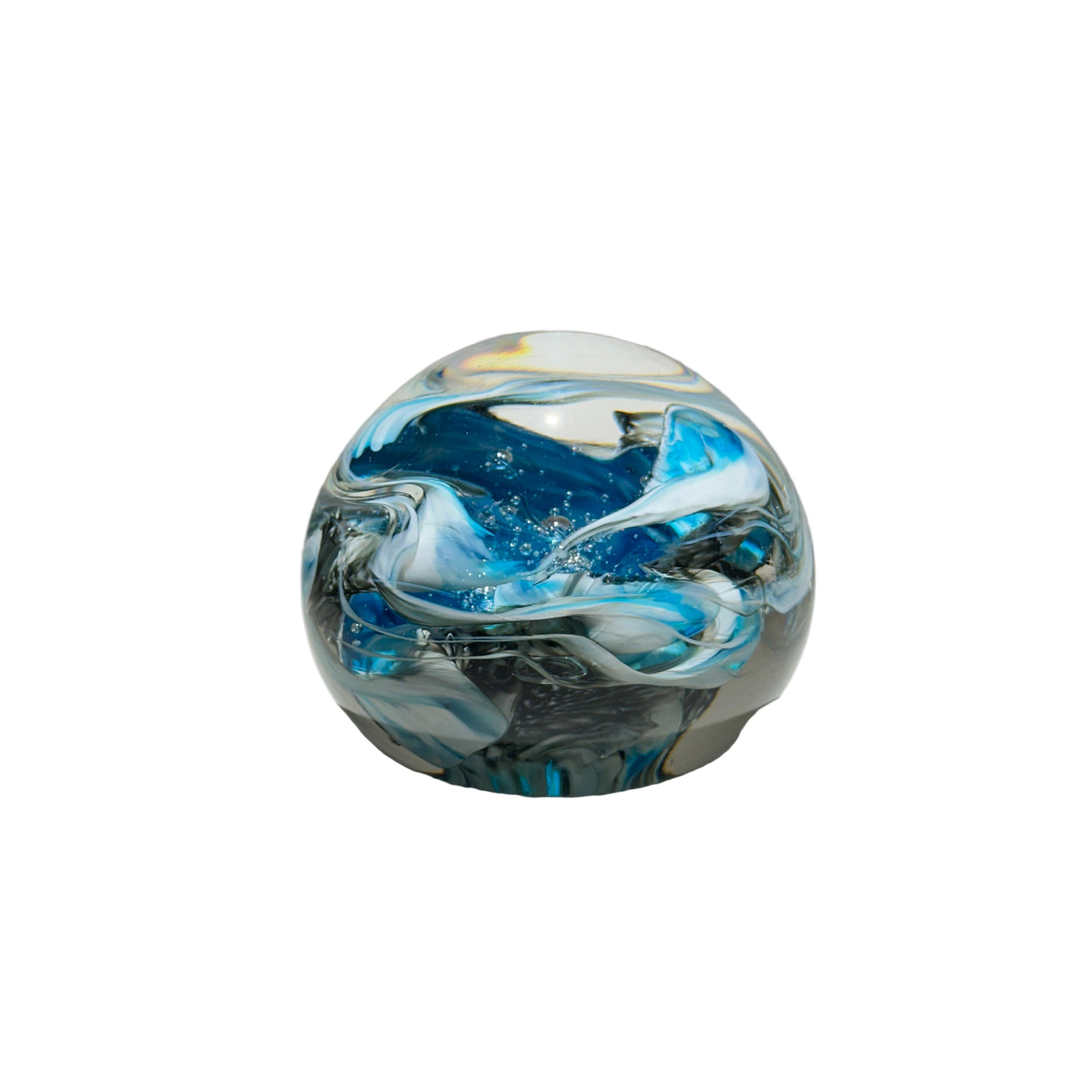 Glass marble with blue and white swirls on a gray background